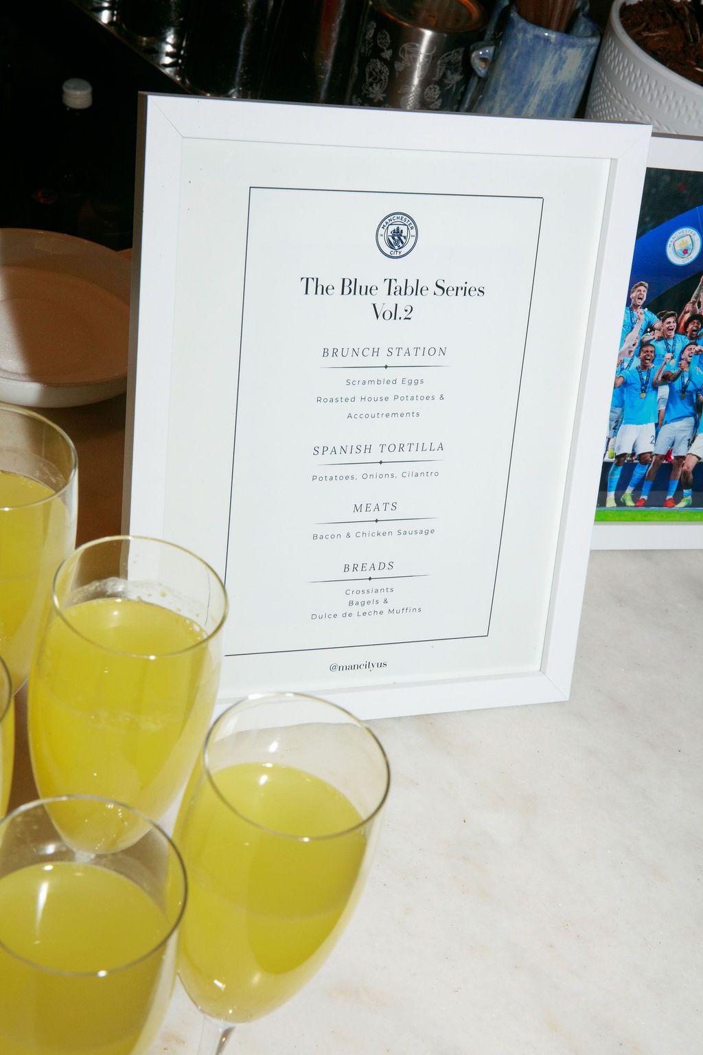 Blue Table Series brunch menu with orange drinks on a table